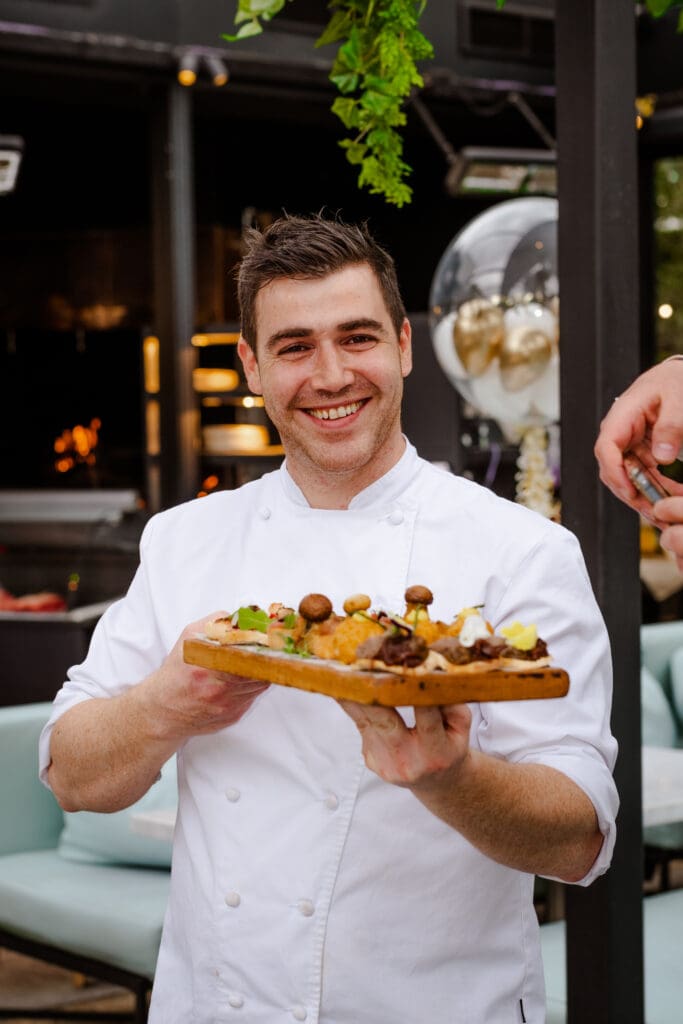 Smiling waiter is serving canapes