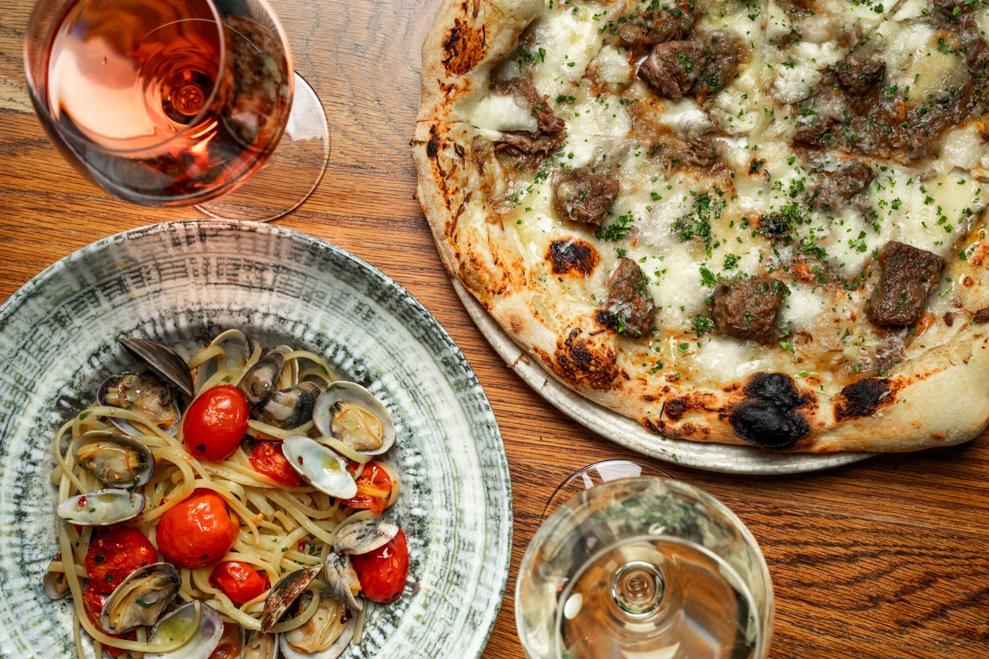 Italian pizza and seafood pasta served with wine